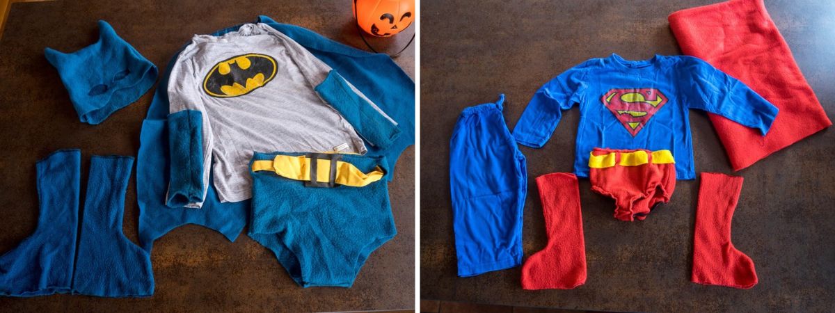 Piezas de los disfraces caseros de Batman y Superman, con camisetas, capas, botas, guantes, calzoncillos y una máscara de Batman.